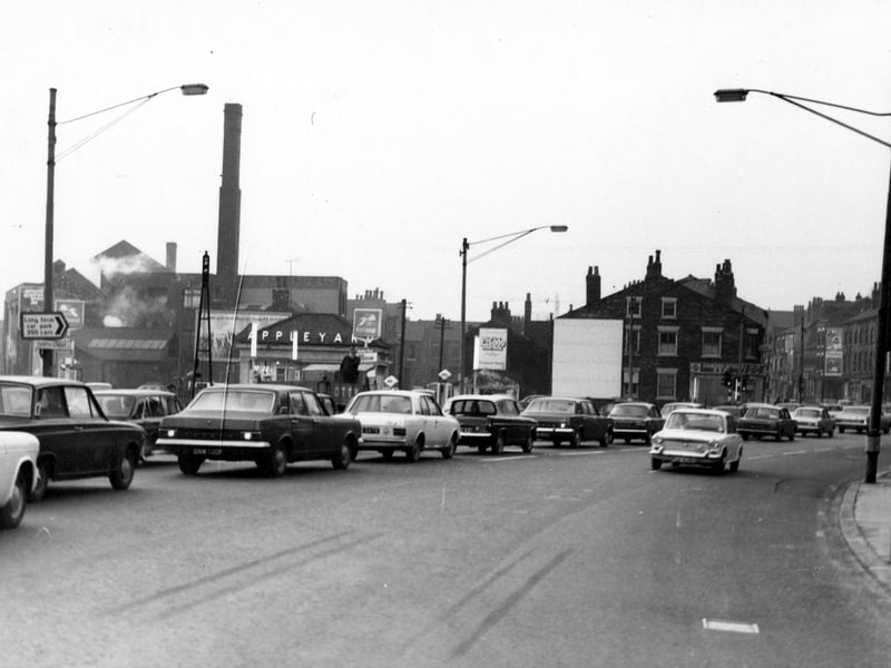 North Street in November 1968. There is a queue of traffic from left to right. On the left is the road sign for North Street, above is one for a 350 space long term car park. In the background is Appleyard's petrol station selling National petrol. In the distance is a tall chimney.