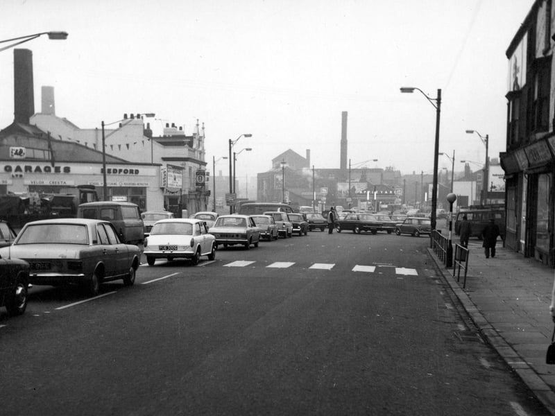 A view looking south towards Sheepscar from the end of Chapeltown Road. On the left is City Garages, advertising Bedford, Velox, Cresta and Vauxhall cars. The garage also has a school of motoring. Next door is the Pointer pub, selling Magnet Ales. In the distance can be seen a National petrol station, with Appleyard of Leeds Ltd. garage behind. Pictured in  November 1968.