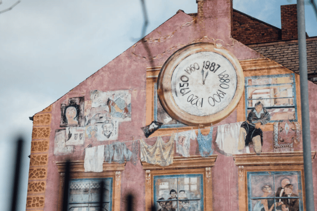 Easily missed on the side of a former textile mill, this isn't just a generic mural. It is a powerful, colourful monument to the local community, as the figures painted into the building's windows are actually portraits of the real employees who worked at the stone cutting company that occupied the premises in the 1980s.