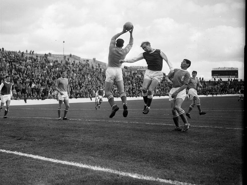 Aberdeen goalkeeper John 'Tubby' Ogston leaps up to catch the ball against Hibs at Easter Road in September 1964.
