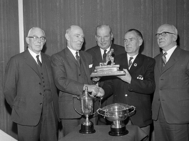 Joe David and John Parke show off the silverware at Easter Road in November 1964.