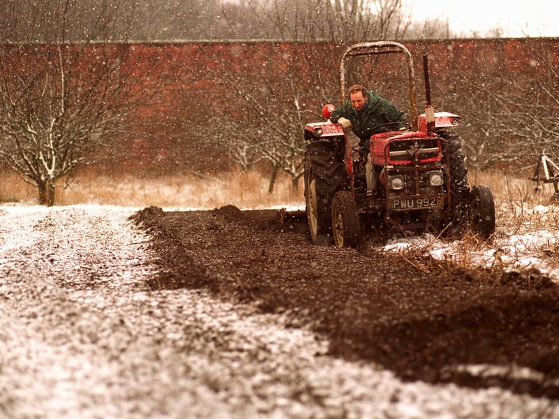 Head gardener Trevor Nicholson hard at work in the sleet and snow transforming the Walled Garden ready for summer.