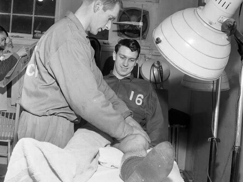 Hibs player Eric Stevenson on the treatment table with trainer Tom McNiven at Easter Road in January 1964.