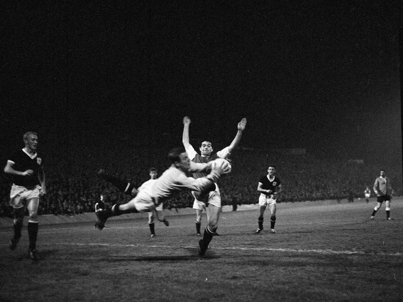 Jim Scott of Hibs challenges Dundee goalkeeper Bert Slater in Hibs' 2-0 Scottish League Cup quarter final win at Easter Road in September 1963.