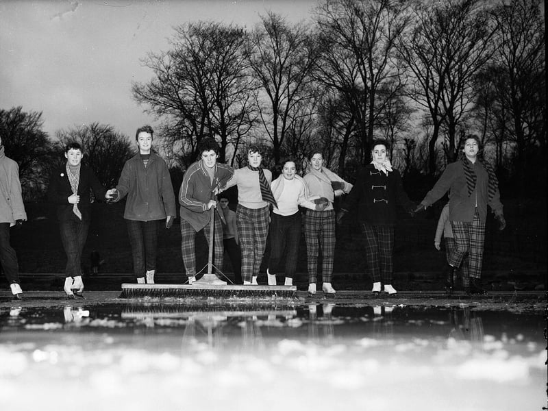 Skaters preparing to clear water off the ice on Inverleith Pond in January 1959.