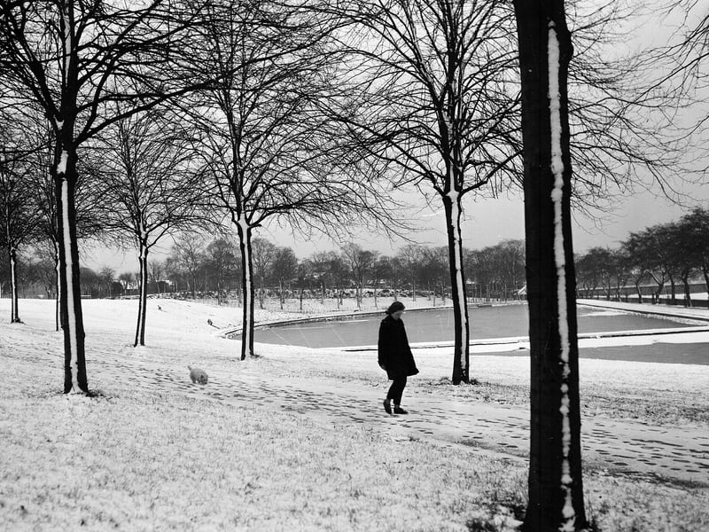 A girl walking beside the frozen pond in Inverleith Park in December 1962