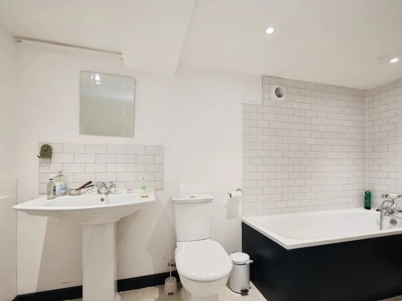 The historic building has been converted into a three bedroom home with two bathrooms and a large living room.