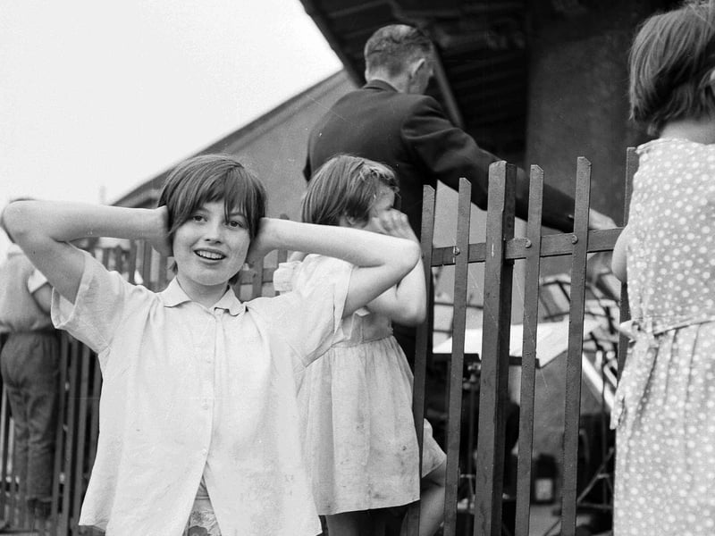 A girl covers her ears as she listens to a band in Inverleith Park in August 1963.