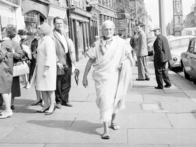 Raymond Duncan, brother of the dancer Isadora Duncan, walks along George Street during the 1963 Edinburgh International Festival. He was voted one of the world's best dressed men in 1962.
