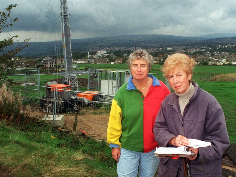 Blot on the landscape. Local residents Amanda Taylor, left and Sue Seeger, in front of the telephone mast on The Billing that was going up despite a petition of more than 500 signatures against it. Pictured in September 1999.