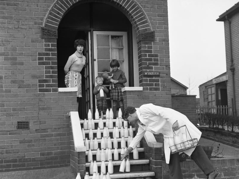 A milkman delivers to a house in Mexborough, South Yorkshire, as part of an advert for the Barnsley Co-op, reminding customers to remember to cancel their delivery when they go on holiday