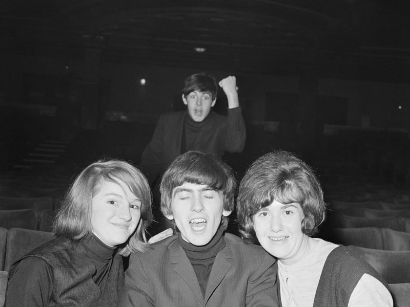 Paul McCartney, of the Beatles, feigns rage while George Harrison 'gets the girls', at the Gaumont Theatre, Doncaster, in December 1963