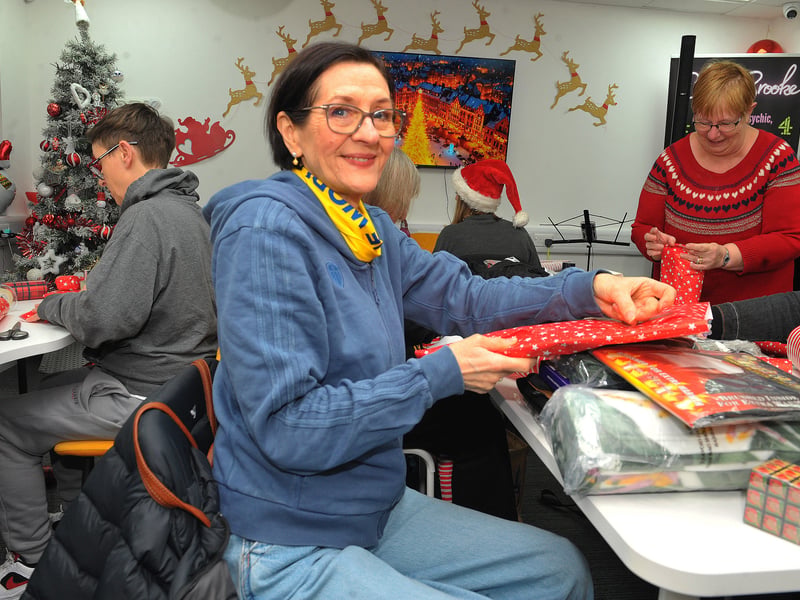 Jane Storr of Bramley helps wrapping presents at the Homeless Street Angels headquarters at Abi House on Sheepscar Court.