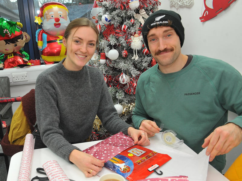 Rebecca Paradise and Haydn Johnson wrapping presents 