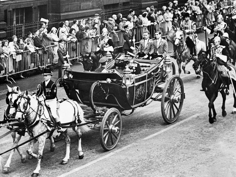 Queen Elizabeth II and King Olav of Norway in the Royal coach as a procession makes its way up Lothian Road during the King's state visit to Scotland in October 1962.