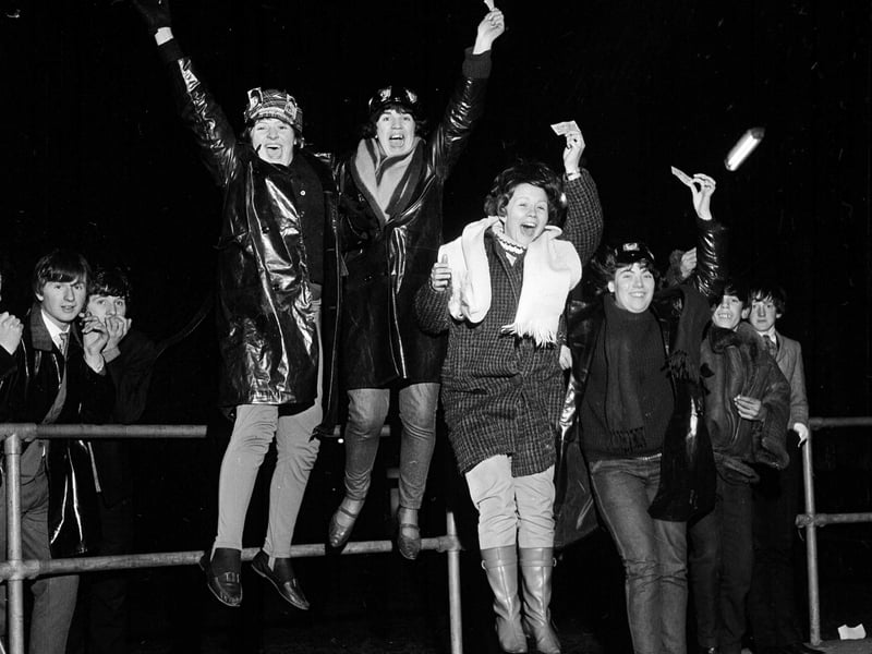 Excited Beatles fans jump for joy after receiving their tickets at the end of their long wait at the ABC on Lothian Road in April 1964.