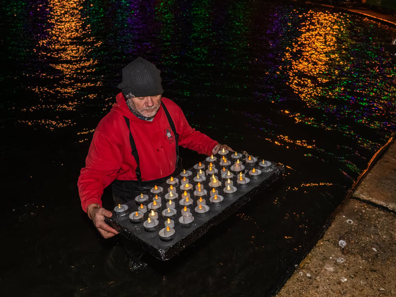 Lake of Lights by Rowans Hospice at Canoe Lake in Southsea. Pictured is more of the candles being placed into the lake. Pictured by Alec Chapman