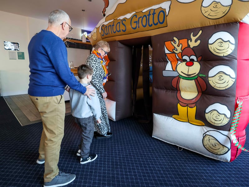 Meeting Father Christmas: Children queue excitedly to meet Father Christmas, who praised the young guests for being on his 'good list' this year.