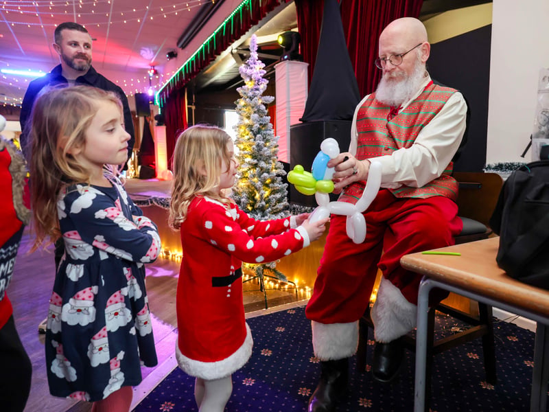 Creative entertainment: Young guests watch in amazement as the balloon artist creates colourful designs.