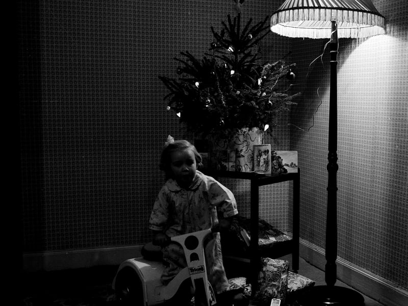 A child with toys on Christmas morning in 1959.