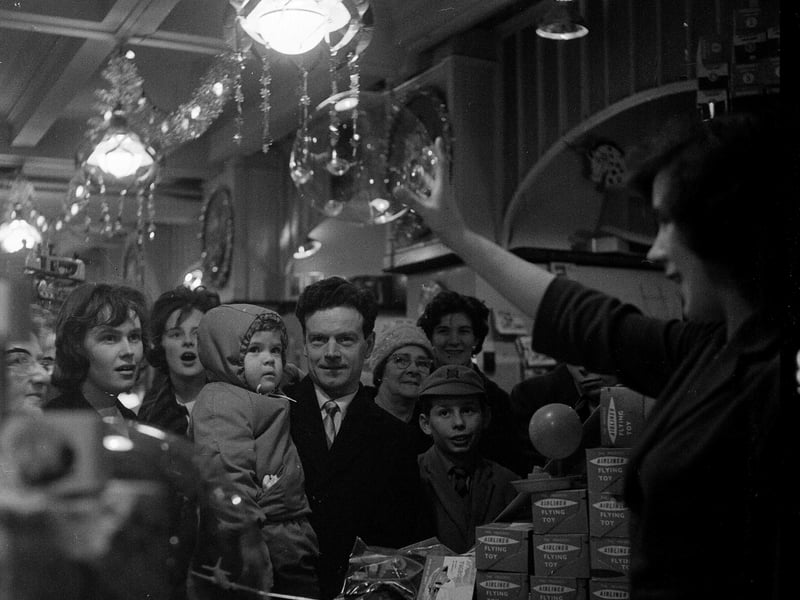 A sales girl demonstrates the latest in plastic balloons to Christmas shoppers in Edinburgh in 1961.