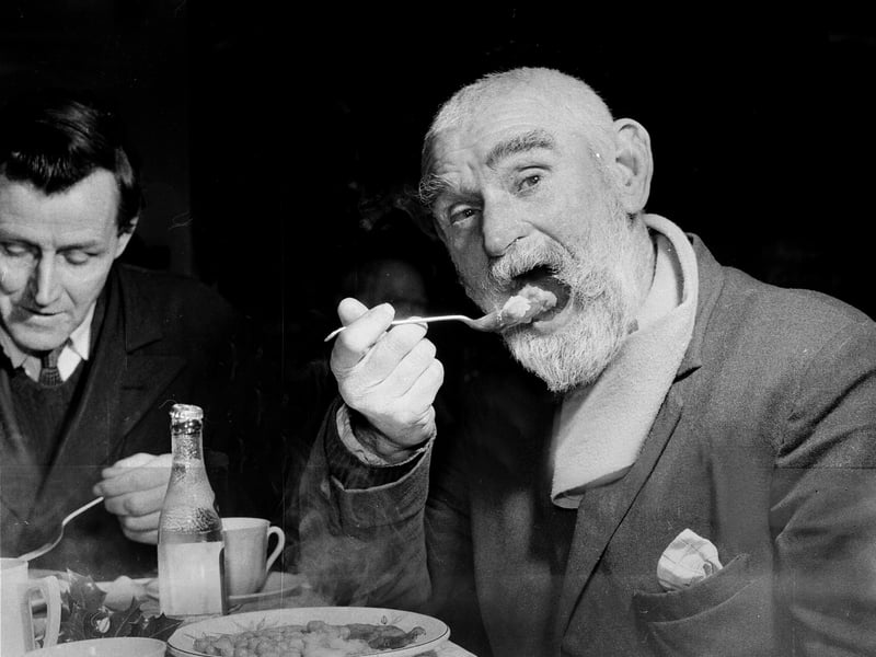The People's Palace Christmas Party at the bottom of Old Fishmarket Close in the Cowgate in 1962. 73 year old Patrick Kane enjoys a meal at the former Edinburgh Sabbath Free Breakfast Mission.