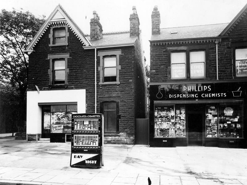 Chapeltown Road which was Phillips chemist premises in August 1939.Business on the left is vacant. Cigarette & chocolate vending machine can be seen on the pavement. Far left is the junction with Harehills Avenue and Newton Grove