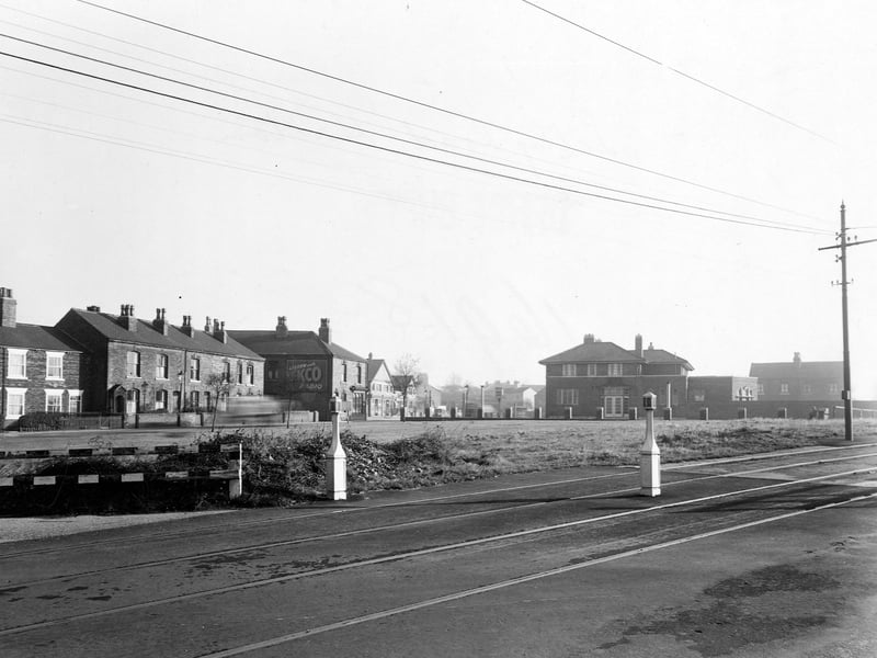 A view from November 1949 looking east along Selby Road at the Irwin Arms pub. In the foreground are tram tracks, power lines and bollards. In the distance is an advertisement for Ecko Radios.