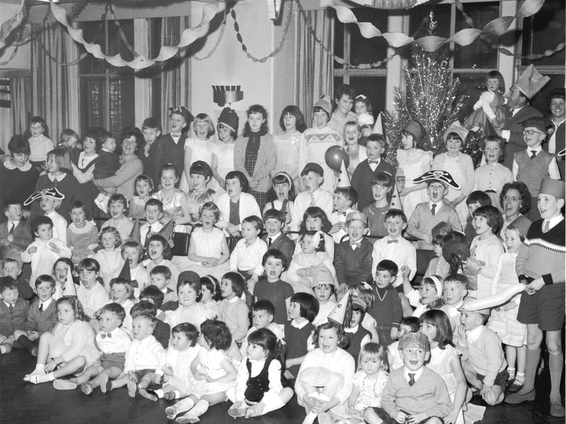 Employees of the machine room of The Scotsman Publications and their children enjoying a Christmas party held in the staff canteen in 1965.
