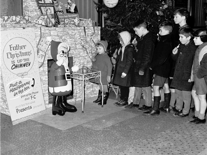 Maureen Lusher of Montague Street talks to Santa Claus on   the telephone from the Odeon cinema.