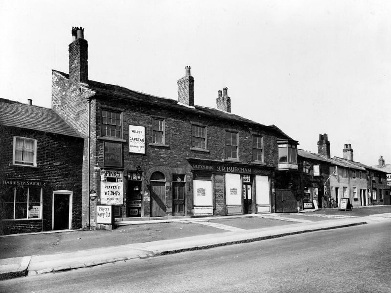 Main Street, on the left George Hardisty saddler, moving right Miss Marion Spink tobacconist. Next, shop which had been business of Joseph Bureham, would open as a branch of Thrift Stores. The last shop which can be seen is a barbers, with pole over door, Albert Broughtons' premises. Pictured in June 1936.