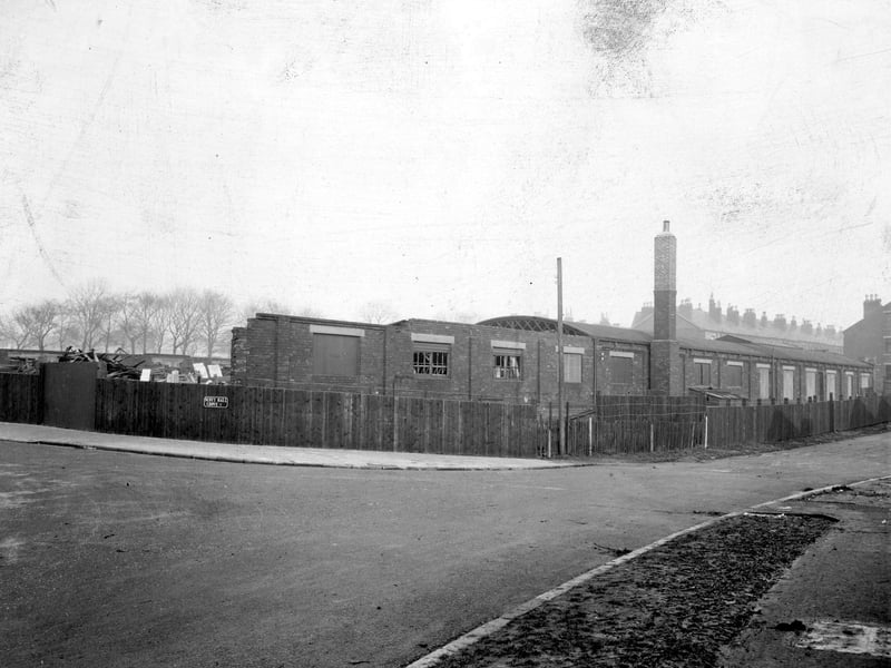 Sholebroke Mount with to the left, the junction with Scott Hall Grove. A single storey building is in a state of dereliction. This was part of the building shown on a map of 1911 as Chapeltown Skating Rink and in 1921 as the Rink Works, bedsteads and bedding.