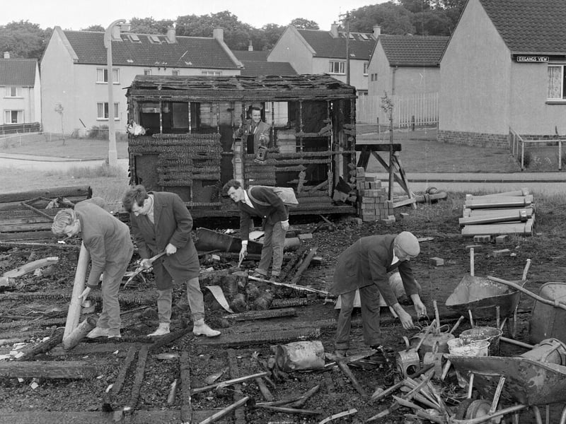 Workmen clear up debris after an explosion in a hut at Oxgangs Bank in June 1965.