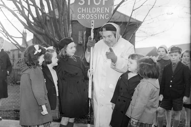 Mollie Harris helping children cross the road in Oxgangs in February 1962.