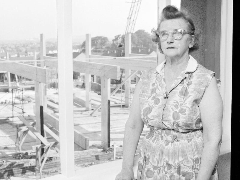 Mrs Cairns at her window showing the new Community Centre being built in August 1965.