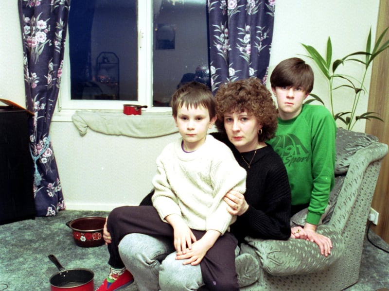 Yvonne Smith and her family pictured in April 1992, when they had to catch the water leaking into their Leith council flat every time it rained