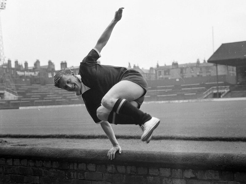 Hearts footballer Don Kerrigan leaps the wall at Tynecastle in July 1965.