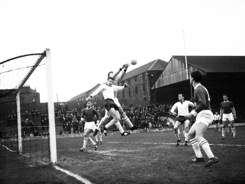 Goalkeeper Mick McVittie beats Tommy Traynor to the ball during a Hearts versus St Johnstone match at Tynecastle Park in January 1966.