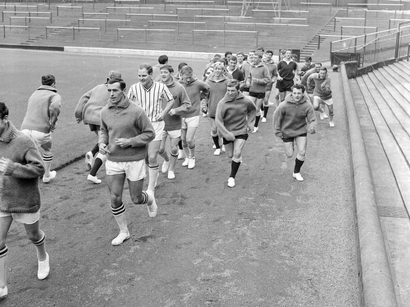 The Hearts football squad running around the track during a training session at Tynecastle in July 1965.
