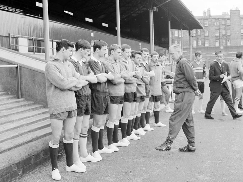 Trainer Johnny Harvey speaks to the Hearts football team before a training session at Tynecastle in July 1965.