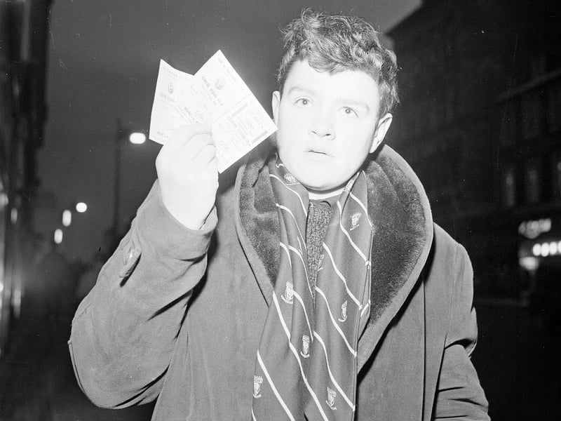 Wearing his official Hearts Supporter scarf, Alex Spence is pictured with his two tickets for the Hearts v Hibs Edinburgh Derby match to be played at Tynecastle on New Year's Day 1965.