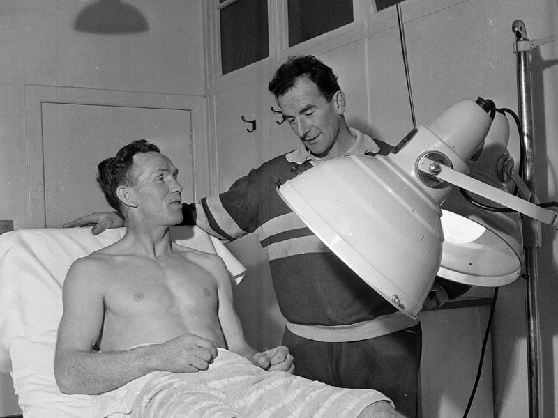 John Cumming of Hearts receives treatment for his injury from Tynecastle trainer Donald McLeod in November 1963.