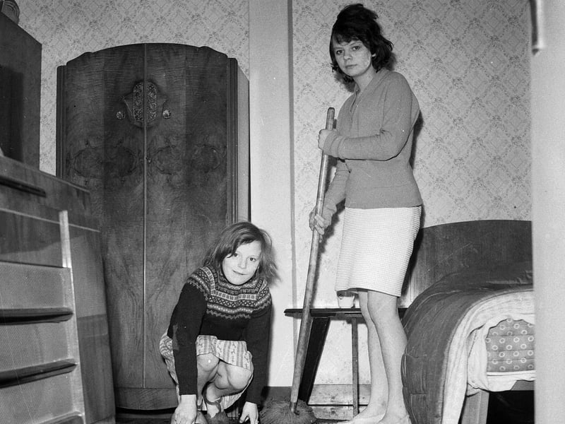 Ellen and Georgina Dalrymple of Chesser Crescent mop up after a burst water main caused flooding in Gorgie in March 1963.