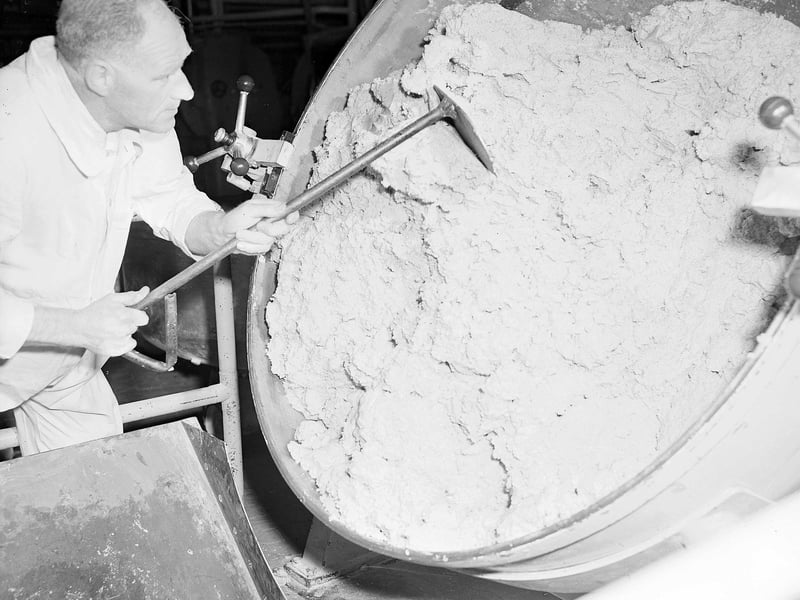 A worker dipping out homewheat dough into a hopper at the McVitie & Price Cake and Biscuit Factory in Gorgie in June 1958.