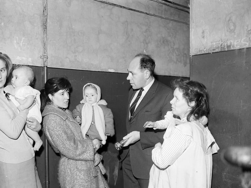 Councillor John Henderson speaks to tenants who had hoped to get new council houses in Freer Street, Fountainbridge, in November 1962.