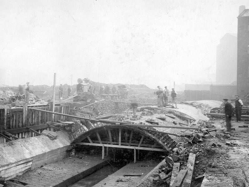 Building work to construct a covering over Lady Beck, near St Peter's Street. Method of construction of brick archway using a timber form can clearly be seen. Several workmen in the background. Pictured in November 1929.