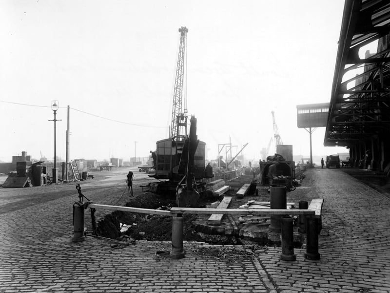 Showing work in progress on a sewer in Hunslet Goods Depot. In the foreground is a trench being dug by a mechanical digger. Pictured in November 1950.