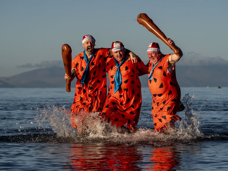 Three dippers brave the cold dressed as Fred Flintstone