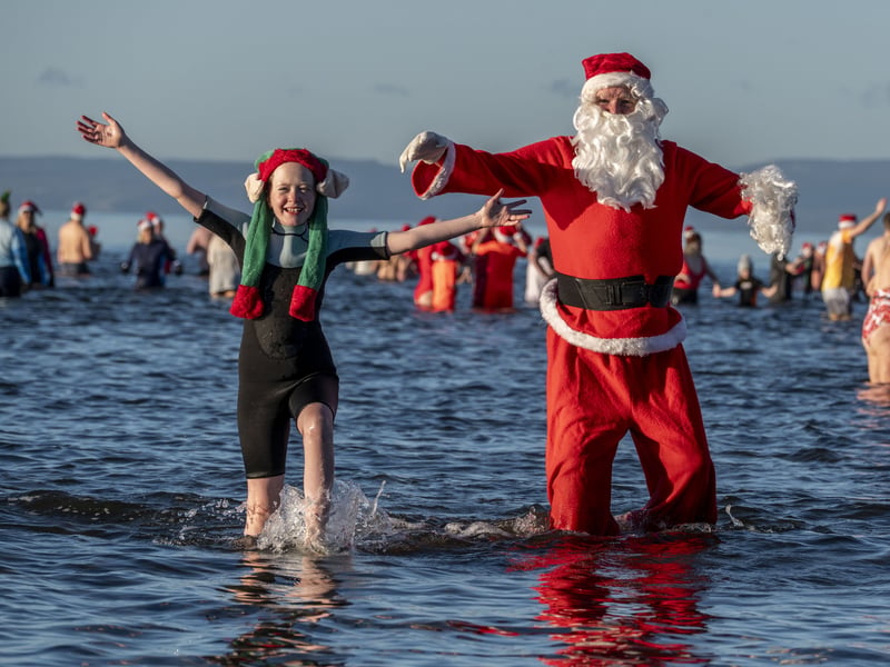 Santa and his elf striking a pose 