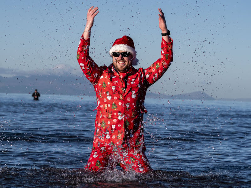 This swimmer took to the sea in full Christmas attire and a pair of sunnies 